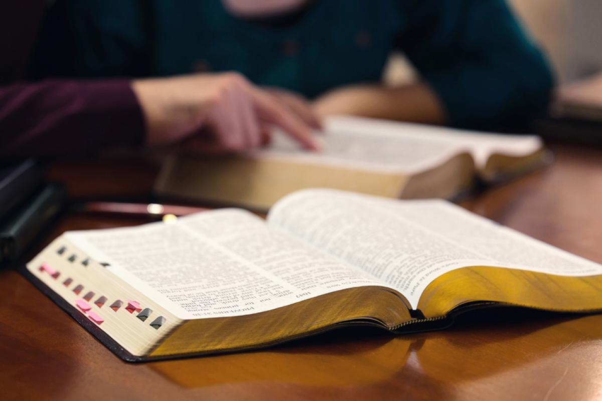 stock photo showing two people reading the bible